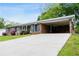 Brick house featuring a carport and a long drive way that leads to the street at 3894 Summit Dr, Douglasville, GA 30135