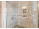 A fully-tiled shower stall with a built-in seat and a clear glass door at 3970 Church View Ln, Suwanee, GA 30024