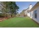 Large backyard with mature trees and a patio area, great for relaxation and gatherings at 4198 Haynes Mill Nw Ct, Kennesaw, GA 30144