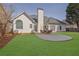 Backyard view of home with a patio and outdoor seating, with ample space for relaxing and green grass at 4198 Haynes Mill Nw Ct, Kennesaw, GA 30144