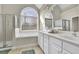 Bright bathroom featuring a walk-in shower, bathtub, double vanity, and large window at 4198 Haynes Mill Nw Ct, Kennesaw, GA 30144