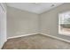 Cozy bedroom with neutral carpet, a window, and closet for ample storage space at 4198 Haynes Mill Nw Ct, Kennesaw, GA 30144