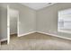 Spacious bedroom featuring neutral carpet and a closet with ample storage space at 4198 Haynes Mill Nw Ct, Kennesaw, GA 30144
