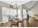 Dining area features ample lighting and a view of the fireplace and backyard at 4198 Haynes Mill Nw Ct, Kennesaw, GA 30144