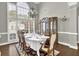 Elegant dining room featuring large windows, hardwood floors, and a stylish chandelier at 4198 Haynes Mill Nw Ct, Kennesaw, GA 30144