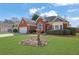 Charming red brick home featuring an attached two-car garage and lush green front yard at 4198 Haynes Mill Nw Ct, Kennesaw, GA 30144