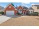 Charming red brick home featuring an attached two-car garage and a well-manicured front yard at 4198 Haynes Mill Nw Ct, Kennesaw, GA 30144