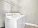 A clean, white laundry room with shelving above the washer and dryer at 4198 Haynes Mill Nw Ct, Kennesaw, GA 30144