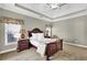 Elegant main bedroom with a large bed, dresser, and plenty of natural light at 4198 Haynes Mill Nw Ct, Kennesaw, GA 30144