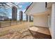 View of the home's back porch, wooden fence, and nearby silos at 10 Dairyland Dr, Covington, GA 30016