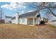 A view of the home and backyard including a covered porch and trees at 10 Dairyland Dr, Covington, GA 30016