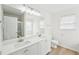 Bright bathroom with a double sink vanity, modern lighting, and a separate shower and tub at 10 Dairyland Dr, Covington, GA 30016