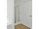 Close-up of a clean, white bathroom featuring a glass-enclosed shower and a white paneled door at 10 Dairyland Dr, Covington, GA 30016