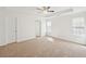 Large, bright, carpeted bedroom featuring a ceiling fan and crown molding at 10 Dairyland Dr, Covington, GA 30016