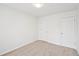 A well-lit bedroom with neutral carpet and two white paneled doors at 10 Dairyland Dr, Covington, GA 30016