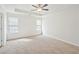 Spacious, carpeted bedroom with ceiling fan, crown molding, and natural light at 10 Dairyland Dr, Covington, GA 30016