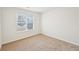 A well-lit bedroom with neutral carpet and a window offering neighborhood views at 10 Dairyland Dr, Covington, GA 30016