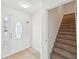 Bright entryway with a decorative glass front door, light wood flooring, and staircase leading upstairs at 10 Dairyland Dr, Covington, GA 30016