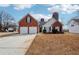 Charming single-Gathering home featuring a brick and siding exterior, two-car garage, and unique silo-inspired architecture at 10 Dairyland Dr, Covington, GA 30016