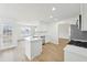 Spacious kitchen with white cabinets, stainless appliances, a breakfast bar, and wood-look flooring at 10 Dairyland Dr, Covington, GA 30016