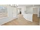 Open-concept kitchen and dining area with white cabinets and a view of the fireplace in the living room at 10 Dairyland Dr, Covington, GA 30016