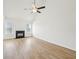 Bright living room with wood floors, a black fireplace, large windows, and a ceiling fan at 10 Dairyland Dr, Covington, GA 30016