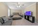 Primary bedroom features soft carpet, neutral paint, a ceiling fan, and a cozy sitting area at 2524 Oakleaf Rdg, Lithonia, GA 30058