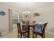 Cozy dining area with a round glass table set near a window, providing a relaxed eating experience at 2524 Oakleaf Rdg, Lithonia, GA 30058