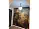 Charming entryway featuring a statement wall mural, black door, and modern light fixture at 3133 Rebecca St, Covington, GA 30014