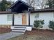 Inviting front porch with a stylish front door and attractive landscaping at 3133 Rebecca St, Covington, GA 30014