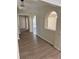 Inviting hallway with arched openings, light-colored walls, and modern lighting fixtures at 3133 Rebecca St, Covington, GA 30014