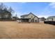 Backyard view showcasing a spacious lawn and a covered patio area for outdoor enjoyment at 3492 Maple Hill Rd, Lithonia, GA 30038