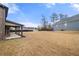 Expansive backyard featuring a covered patio and ample space for outdoor activities at 3492 Maple Hill Rd, Lithonia, GA 30038