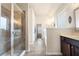 Well-lit bathroom featuring a glass-enclosed shower, garden tub, and vanity with cabinetry at 3492 Maple Hill Rd, Lithonia, GA 30038