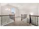 Spacious loft area with high ceilings, decorative chandelier and iron railing at 3492 Maple Hill Rd, Lithonia, GA 30038