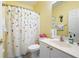 Bright bathroom featuring a floral shower curtain, white vanity, and a neutral color scheme at 3832 Abbott Ln # 1, Powder Springs, GA 30127