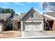 Charming townhome featuring a two-car garage, brick accents, and a well-maintained lawn at 3832 Abbott Ln # 1, Powder Springs, GA 30127