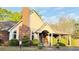 Attractive building exterior with brick chimney, decorative shrubbery, arched windows, and covered entry at 3832 Abbott Ln # 1, Powder Springs, GA 30127