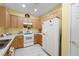 Well-lit kitchen featuring updated appliances, light wood cabinets, and neutral countertops at 3832 Abbott Ln # 1, Powder Springs, GA 30127