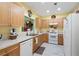 Well-lit kitchen featuring light wood cabinets, white appliances, and neutral countertops at 3832 Abbott Ln # 1, Powder Springs, GA 30127