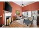 Bright living room features a fireplace, lots of natural light, and a vaulted ceiling with a fan at 3832 Abbott Ln # 1, Powder Springs, GA 30127