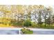 Beautifully landscaped street view with mature trees, shrubs, and well-maintained greenery at 3832 Abbott Ln # 1, Powder Springs, GA 30127