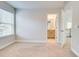 Bedroom showcasing a large window, neutral walls, and carpet flooring at 4450 Heatherwood Sw Dr, Atlanta, GA 30331