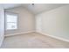 Bedroom with a large window, neutral walls, and carpet flooring at 4450 Heatherwood Sw Dr, Atlanta, GA 30331