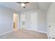 Bedroom featuring a ceiling fan, with doorways leading to an en-suite bathroom and hallway at 4450 Heatherwood Sw Dr, Atlanta, GA 30331