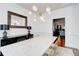 Bright dining room with a modern chandelier and a long table with stylish decor at 4450 Heatherwood Sw Dr, Atlanta, GA 30331