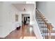 Elegant foyer featuring hardwood floors and a staircase with iron railings at 4450 Heatherwood Sw Dr, Atlanta, GA 30331