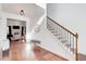 Beautiful foyer featuring hardwood floors, staircase, and a glimpse of the living area at 4450 Heatherwood Sw Dr, Atlanta, GA 30331