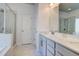 Bright main bathroom featuring dual sinks, a shower and a separate tub at 4450 Heatherwood Sw Dr, Atlanta, GA 30331