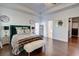 Bright main bedroom featuring a tray ceiling, hardwood floors, and access to a walk-in closet at 4450 Heatherwood Sw Dr, Atlanta, GA 30331